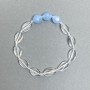 Bracelet with twisted oval rock crystal, 12x8x4 mm + faceted aquamarine bead 10x8.5 mm, 18 cm stretch