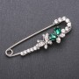 Brooch-pin with green crystals 76×23 mm white metal