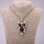Pendant 'Owl' with blue crystals on a long chain of black-gold metal, diameter 41×62 mm, length 70 cm