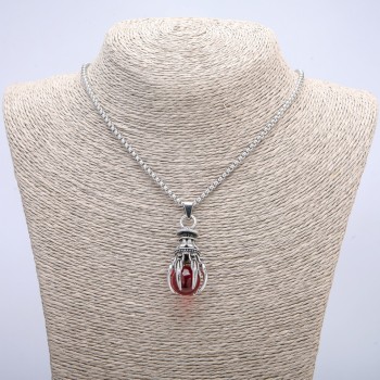Pendant 'Ball in the Paw', red, 45×17 mm on a chain, length about 70 cm, silver-tone metal