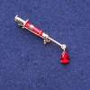 Syringe Brooch with Red Crystal