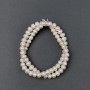 Oval freshwater pearls with a 'gasoline' tint on a thread, diameter 7x5mm, length approximately 39 cm.