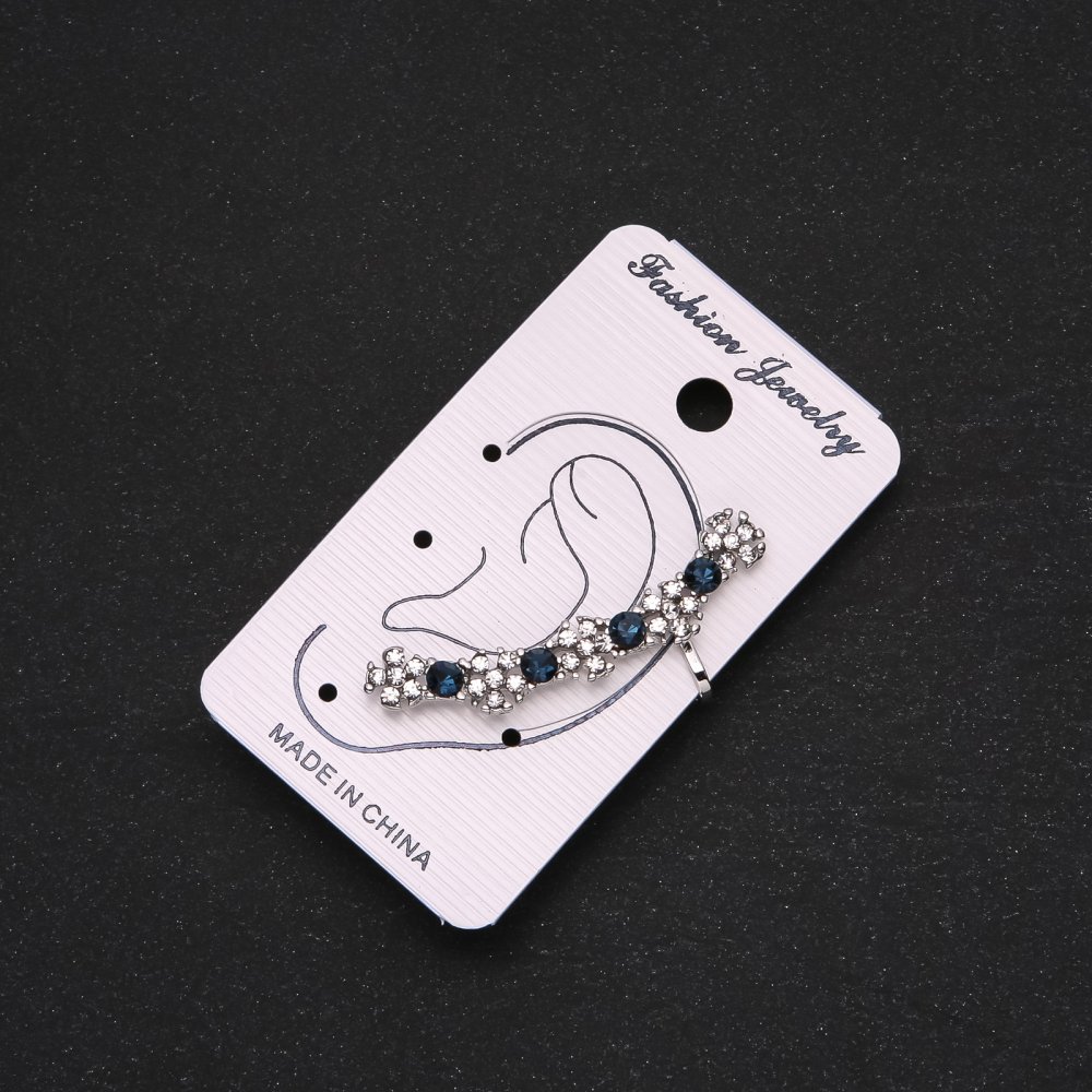 Silver-tone clip-on earring with blue rhinestones and white flowers