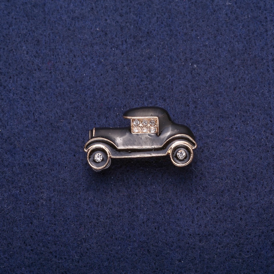 Brooch 'Car' with black enamel and crystals, gold-tone metal 17x29mm