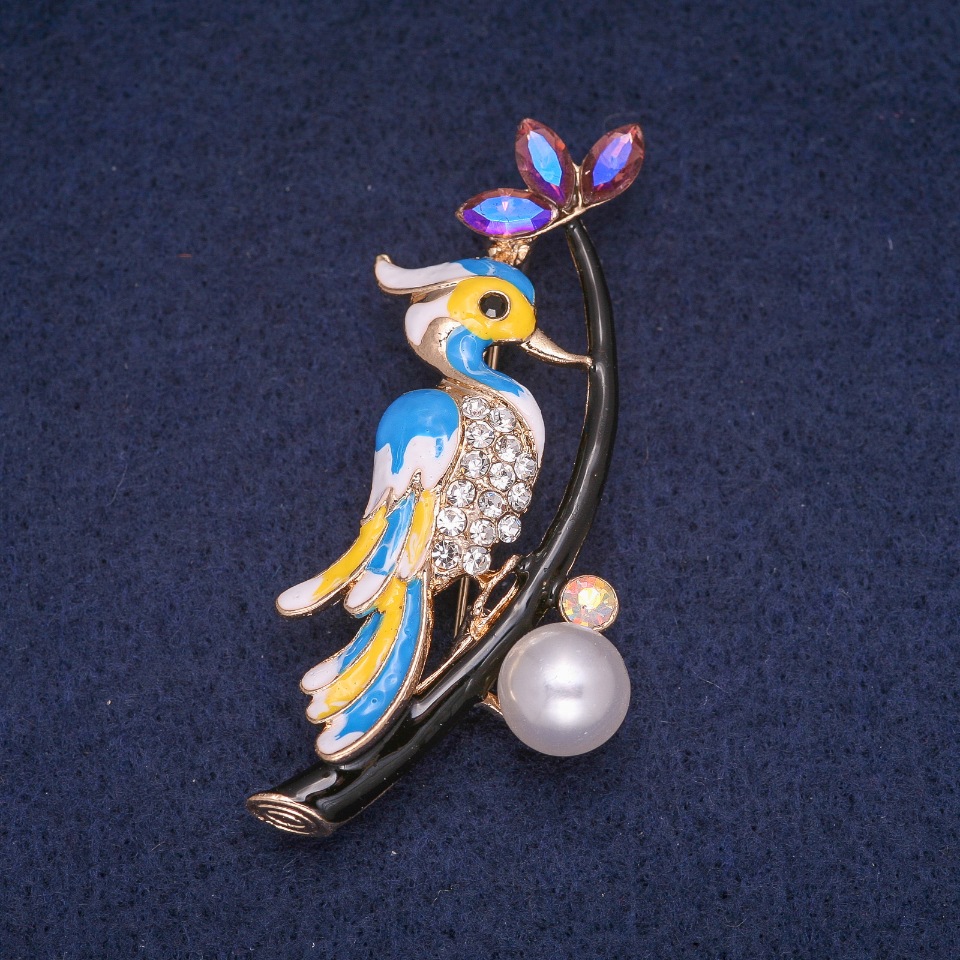 Brooch 'Bird on a Branch' with Enamel and Crystals, gold-tone metal 34x60 mm