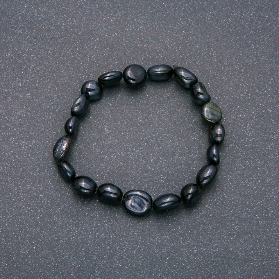 Bracelet made of natural Falcon's Eye stone on elastic with hammered texture, bead size 10x12 mm (±), circumference 18 cm