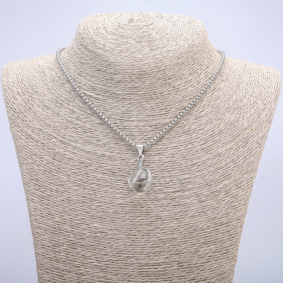 Pendant 'Ball in the Paw' 35x17 mm on a chain, length 70 cm +/- silver-toned metal