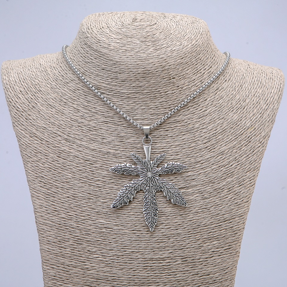 Pendant 'Hemp Leaf' with white rhinestone, 72x53 mm, on a chain, 65 cm length, silver-toned metal color