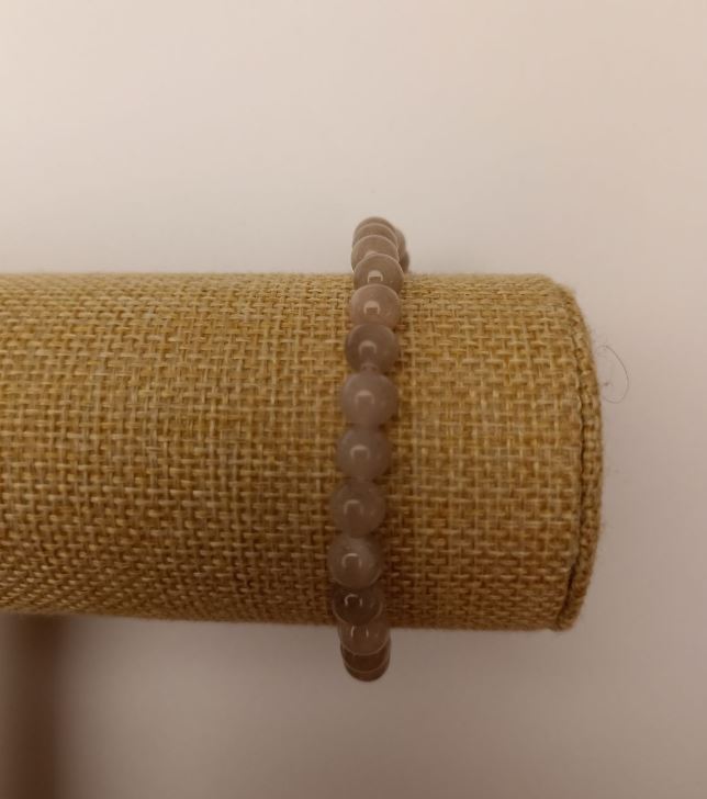 Elastic bracelet with tinted quartz (artificial acrylic) gray smooth beads, 6.5 mm diameter, length 18 cm