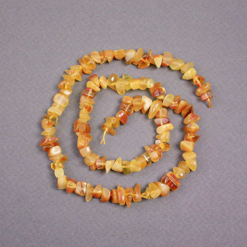 Amber chip beads on thread, diameter 7x4 mm +/-, length 39 cm+